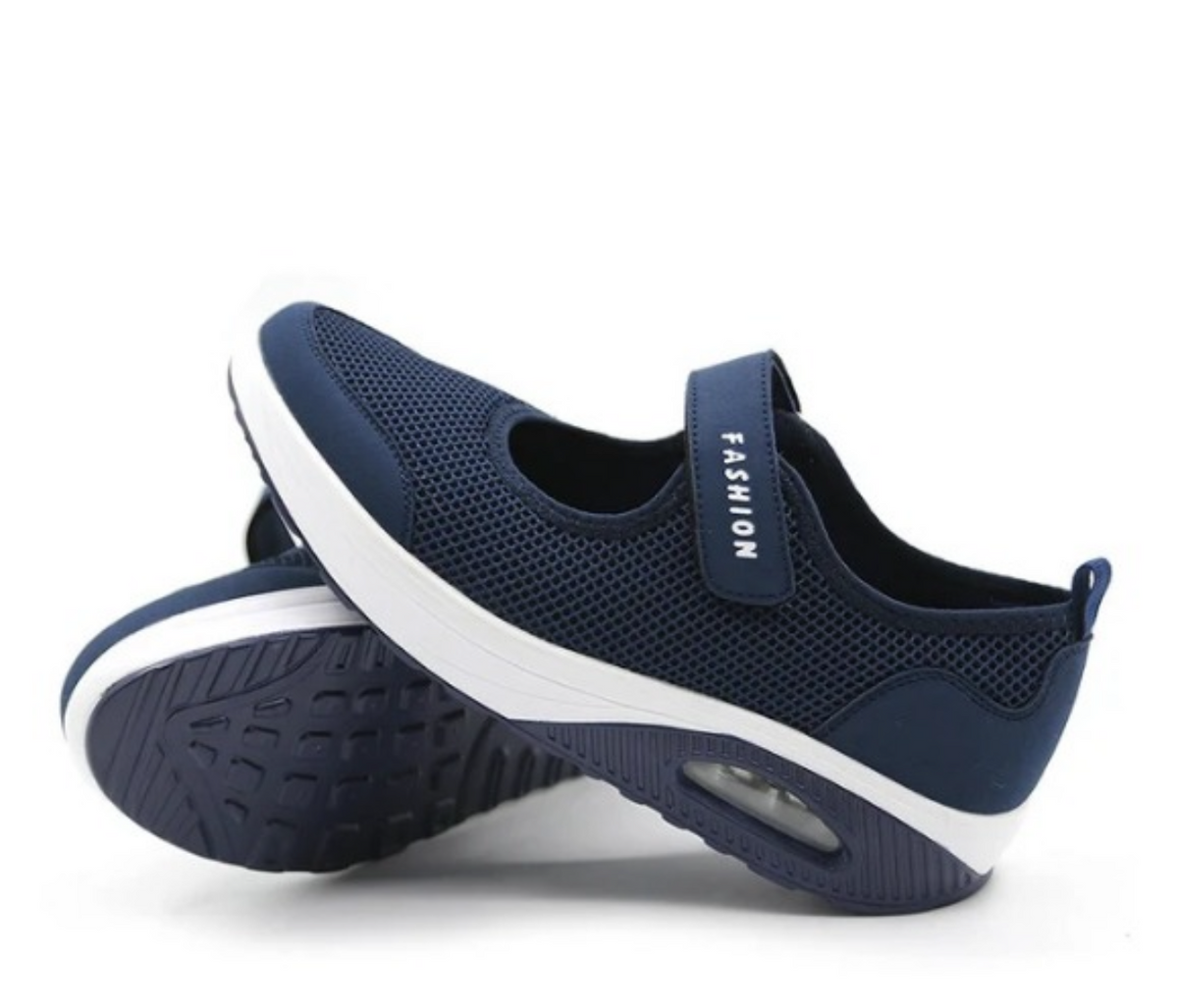 Navy mesh slip-on trainers with an adjustable strap and white wedge sole
