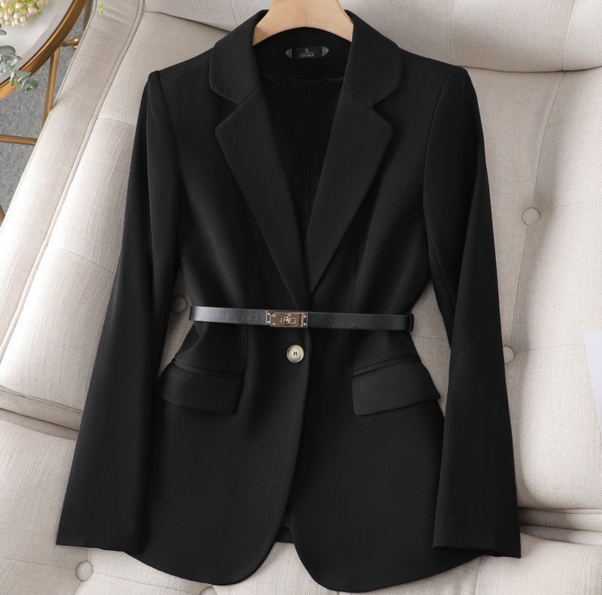 Black tailored single-button blazer with a slim buckle belt at the waist