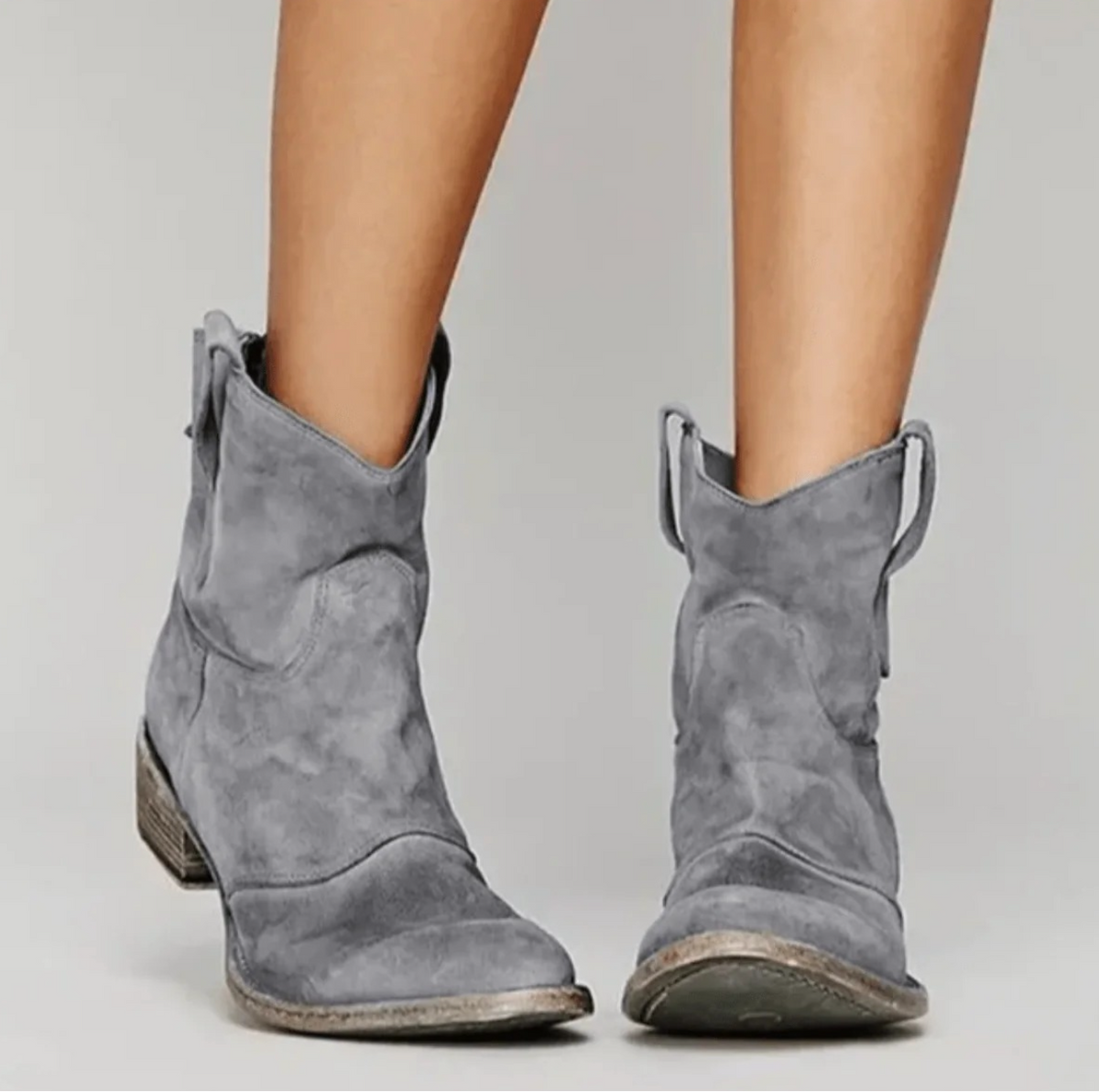 Pair of grey suede western ankle boots with a V-cut shaft and low stacked heel
